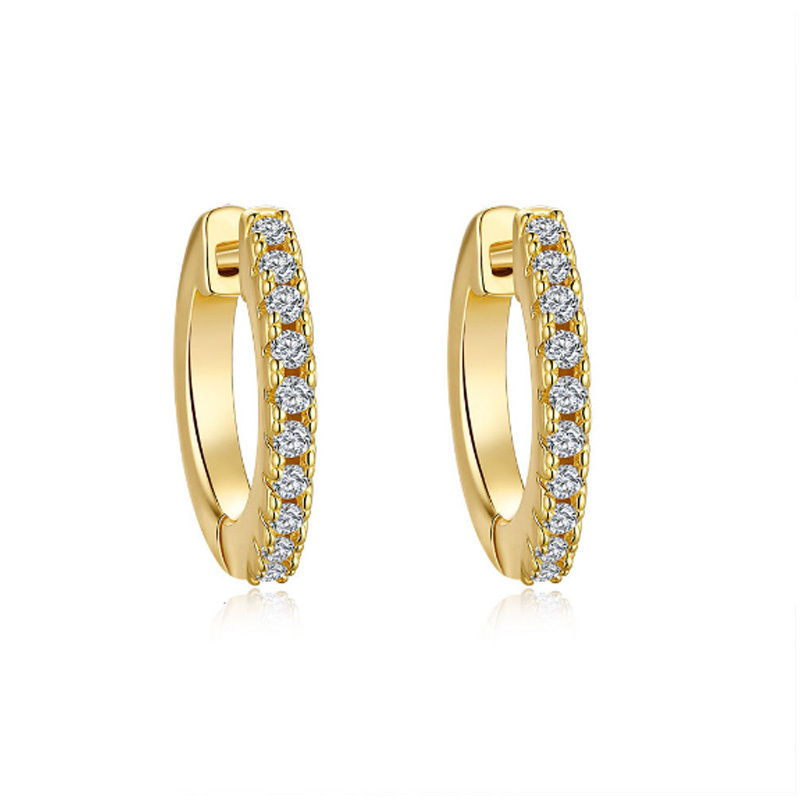 A pair of gold-tone huggie earrings fully set with a row of small white cubic zirconia stones