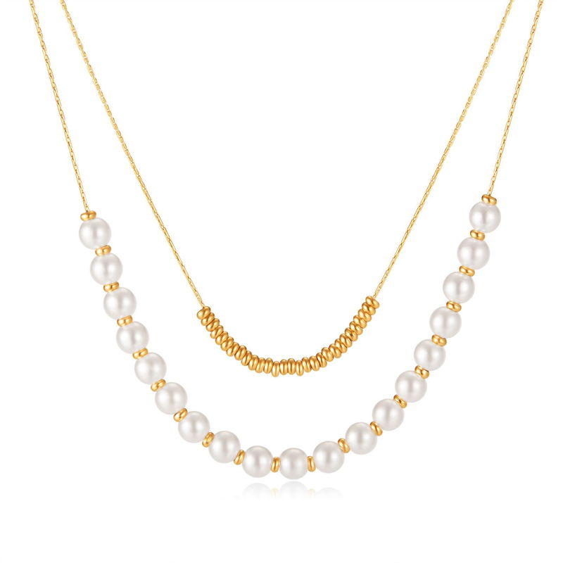 Two gold-tone bead and pearl chain necklaces laid out on a white background